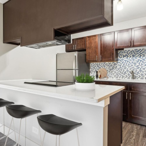 a kitchen with a bar stool and a table