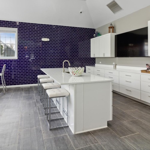 a community kitchen with white cabinets