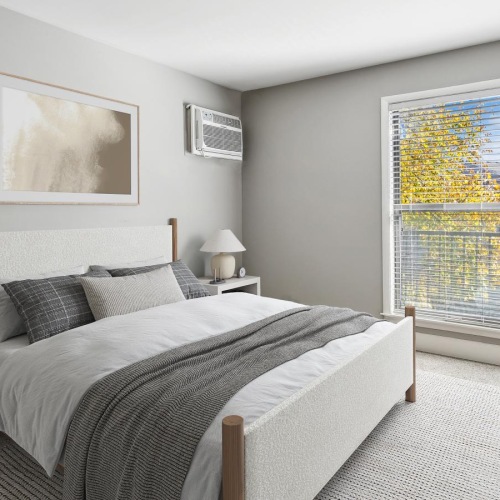 a bedroom with a bed and a window