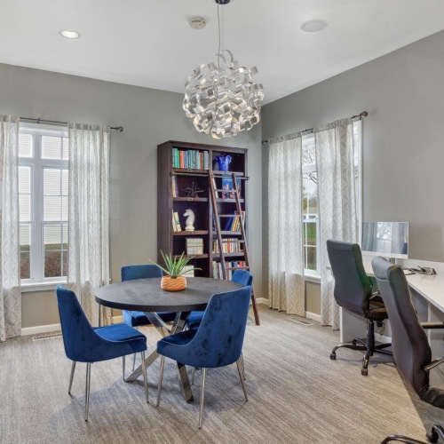 a clubroom with tables and chairs
